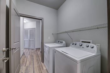 Laundry room with washer and dryer units